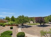 Thumbnail 1 of 10 - A sunny day in a courtyard with a clear blue sky.