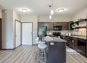 Thumbnail 7 of 10 - A kitchen with a bar stool and a counter. at The Cielo Apartments, Fridley, Minnesota