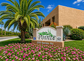 Thumbnail 1 of 23 - A sign for Pointe at 3200 Baristo Rd is in front of a building and a palm tree.
