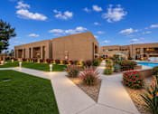 Thumbnail 5 of 23 - A modern building with a well-maintained garden in front.