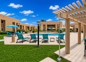 Thumbnail 9 of 23 - A pool surrounded by chairs and umbrellas with a building in the background.