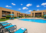 Thumbnail 10 of 23 - A pool area with sun loungers and umbrellas.