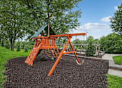 Thumbnail 9 of 25 - A playground with a swing set and a green roof at Aster Meadow, Vadnais Heights, MN, 55127