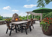 Thumbnail 8 of 25 - A patio with a table, chairs, and a fireplace at Aster Meadow, Vadnais Heights, MN, 55127