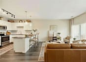 Thumbnail 14 of 25 - A modern kitchen with a brown sofa in front of it at Aster Meadow, Vadnais Heights, MN, 55127