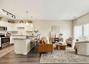 Thumbnail 16 of 25 - A modern kitchen with a dining area and a living room at Aster Meadow, Vadnais Heights, MN, 55127
