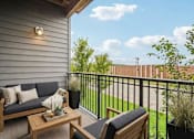 Thumbnail 25 of 25 - A balcony with a sofa, coffee table and potted plants at Aster Meadow, Vadnais Heights, MN, 55127