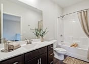 Thumbnail 24 of 25 - A bathroom with a white sink, toilet, and bathtub at Aster Meadow, Vadnais Heights, MN, 55127