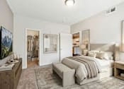 Thumbnail 20 of 25 - A bedroom with a large bed, a nightstand, and a painting on the wall at Aster Meadow, Vadnais Heights, MN, 55127