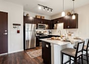 Thumbnail 19 of 25 - A kitchen with a table and chairs set for two at Aster Meadow, Vadnais Heights, MN, 55127