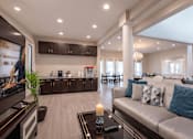 Thumbnail 5 of 25 - A modern living room with a large couch and a coffee table.