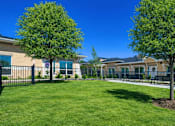 Thumbnail 9 of 25 - A sunny day at a residential area with houses and green trees.