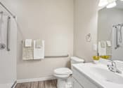 Thumbnail 41 of 41 - Accessible bathroom with grab bars and walk-in shower at The Hendrickson Apartments, Falcon Heights