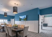 Thumbnail 8 of 41 - Community dining room with pendant lighting at The Hendrickson Apartments, Falcon Heights, Minnesota