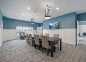 Thumbnail 10 of 41 - Community dining room with large table and seating at The Hendrickson Apartments, Minnesota