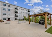Thumbnail 13 of 41 - Outdoor patio with grilling station and pergola at The Hendrickson Apartments, Falcon Heights, MN 55113