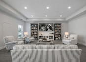 Thumbnail 12 of 41 - Theater room with striped seating and builtin shelving at The Hendrickson Apartments, Falcon Heights, Minnesota