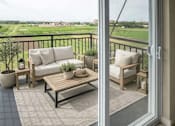 Thumbnail 32 of 41 - Furnished balcony overlooking open green fields at The Hendrickson Apartments, Minnesota, 55113