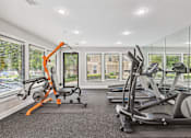 Thumbnail 5 of 16 - A gym with orange and black equipment.