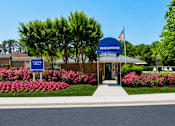 Thumbnail 2 of 17 - The Morrowood sign is blue and white with an American flag on it.
