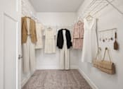 Thumbnail 22 of 25 - Walk-in closet with organized shelving at Connect at First Creek Apartments, Denver, 80249