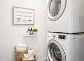 Thumbnail 23 of 25 - Stacked washer and dryer in modern laundry space at Connect at First Creek Apartments, Denver, 80249