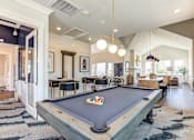 Thumbnail 5 of 25 - Game room with pool tables and modern lighting at Connect at First Creek Apartments, Denver, CO
