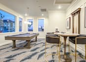 Thumbnail 4 of 25 - Game room with pool table and seating at Connect at First Creek Apartments, Denver