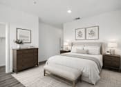 Thumbnail 12 of 16 - A bedroom with a large bed, a dresser, and a nightstand.