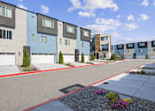 Thumbnail 1 of 16 - A row of modern townhouses with garages and landscaped front yards.
