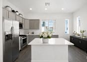 Thumbnail 10 of 16 - A modern kitchen with a large island in the center.