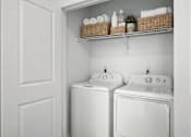Thumbnail 16 of 16 - A white laundry room with a washer and dryer.