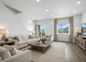 Thumbnail 3 of 16 - A modern living room with a large grey sofa and a wooden coffee table.