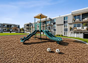 Thumbnail 8 of 26 - Playground with slides and soccer balls at Park Station Apartments, Midvale, 84047