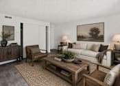 Thumbnail 13 of 26 - Living room with neutral tones and wood accents at Park Station Apartments, Midvale, UT 84047