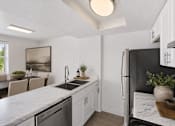 Thumbnail 19 of 26 - Kitchen with dining area and modern finishes at Park Station Apartments, Utah, 84047