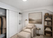 Thumbnail 22 of 26 - Reading nook with armchair and open closet at Park Station Apartments, Midvale, 84047