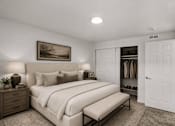 Thumbnail 24 of 26 - Spacious bedroom with walk-in closet and bench at Park Station Apartments, Midvale