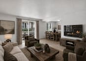 Thumbnail 26 of 26 - Living and dining area with fireplace at Park Station Apartments, Utah, 84047