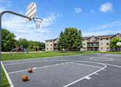 Thumbnail 11 of 23 - A basketball court with a basketball hoop and three basketballs on the ground.