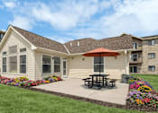 Thumbnail 10 of 23 - A building with a brown roof and a picnic table in front of it.