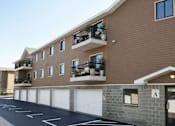Thumbnail 13 of 23 - Apartment building with a parking lot in front.