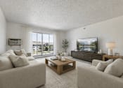 Thumbnail 2 of 23 - A living room with a large window, a flat screen TV, and a coffee table.