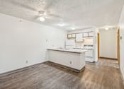 Thumbnail 25 of 38 - A kitchen with white cabinets and a wooden island.