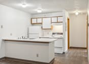 Thumbnail 35 of 38 - A kitchen with white appliances and a white counter.