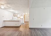 Thumbnail 37 of 38 - A kitchen with white cabinets and a wooden floor.