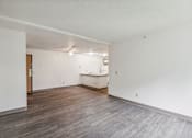 Thumbnail 34 of 38 - A room with a wooden floor and a white wall.
