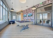 Thumbnail 22 of 39 - Game room with pool table and pendant lighting at Sequel Homes Apartments, Englewood, CO 80110