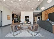 Thumbnail 5 of 39 - Lobby reception area with wood accent wall at Sequel Homes Apartments, Colorado