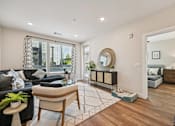 Thumbnail 25 of 39 - Bright living room with wood flooring and bedroom view at Sequel Homes Apartments, Colorado, 80110
